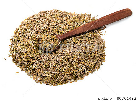 wooden spoon on pile of cumin seeds on white 80761432