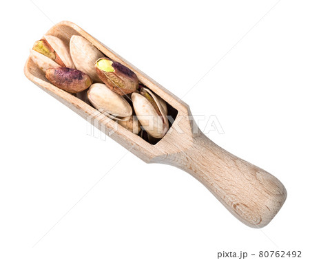 peeled and unpeeled Pistachio nuts in wooden scoop 80762492