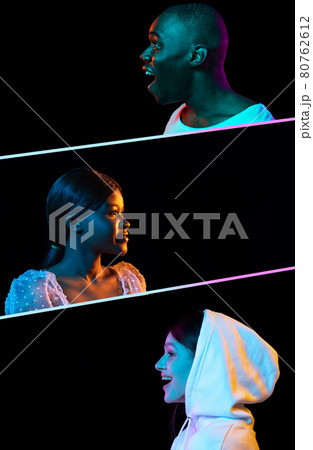 Side view portraits of three smiling, happy, positive people isolated over black background in neon lights. 80762612