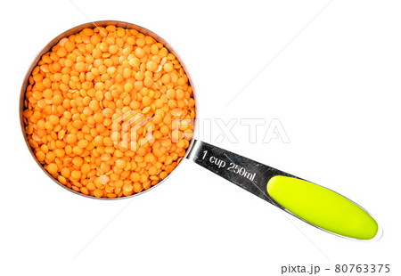 hulled red lentils in measuring cup cutout 80763375