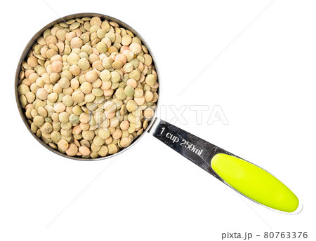 whole light green lentils in measuring cup cutout 80763376