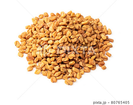 handful of Fenugreek seeds closeup on white handful of Fenugreek seeds closeup on white 80765405