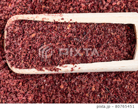 top view of scoop on pile of sumac powder closeup 80765451