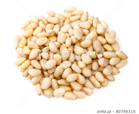 pile of unpeeled pine nuts closeup on white 80766310