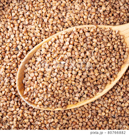 roasted buckwheat grains in wooden spoon closeup 80766882