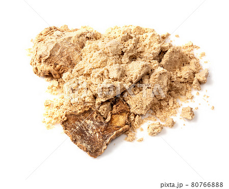 pile of dried ginger roots and powder on white 80766888