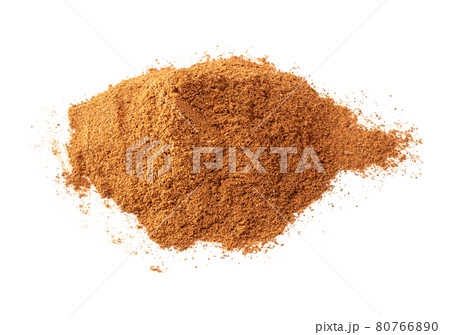 handful of cinnamon powder closeup on white 80766890