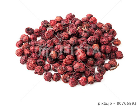 handful of dried magnolia berries closeup on white 80766893