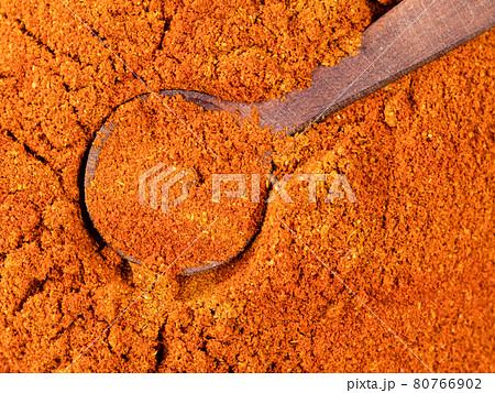 spoon on chili powder from cayenne pepper closeup spoon on chili powder from cayenne pepper closeup 80766902