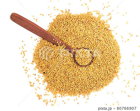 view of spoon on yellow seeds of oriental mustard 80766907