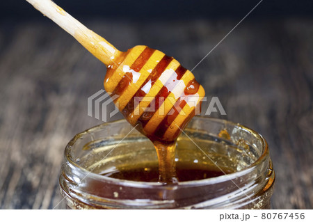 old table on which there is a healthy and sweet bee honey old table on which there is a healthy and sweet bee honey 80767456