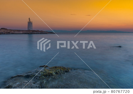 Old small lighthouse of the Aegina island, Saronic gulf, Greece, at sunset. Old small lighthouse of the Aegina island, Saronic gulf, Greece, at sunset. 80767720