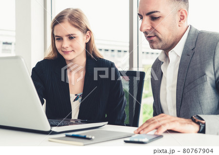 Businessman and businesswoman working in office. Businessman and businesswoman working in office. 80767904