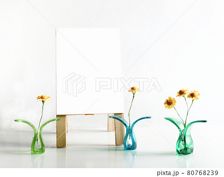 プラスチッククリップに挟んだ黄色い花と白色の立て看板のコピースペース 80768239