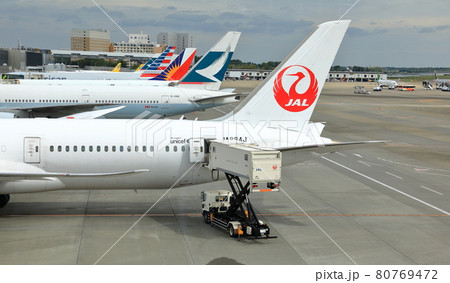 Process of Pre-flight service and handling. Luggage and catering loading at Narita Airport. Process of Pre-flight service and handling. Luggage and catering loading at Narita Airport. 80769472