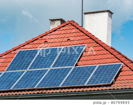 Solar panels installed on the red tiled roof of a house Europe. Solar panels installed on the red tiled roof of a house Europe. 80769693