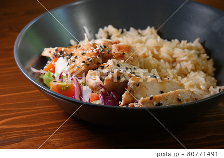 Curry indian food - bowl of stir spicy rice with chicken and vegetables on wooden table 80771491