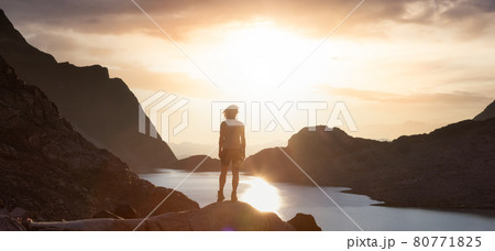 Adventurous Caucasian Adult Woman Hiking on top of a Canadian Rocky Mountain Adventurous Caucasian Adult Woman Hiking on top of a Canadian Rocky Mountain 80771825