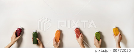 Human hands holding fresh juices in bottles, copy Human hands holding fresh juices in bottles, copy 80772030