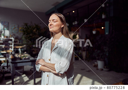 Young caucasian happy seller woman at botanic shop Young caucasian happy seller woman at botanic shop 80775228