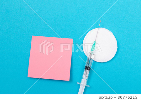 Vaccination or Revaccination Concept - A Medical Syringe on Blue Table 80776215