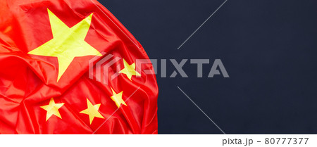 Chinese flag on dark background. 80777377
