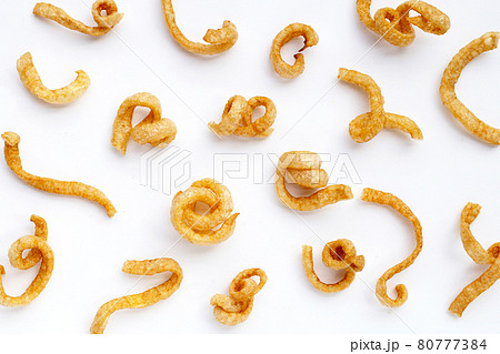 Fried crispy pork rinds on white background. Fried crispy pork rinds on white background. 80777384