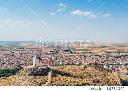 Windmills in a hill with a village in the background 80781362