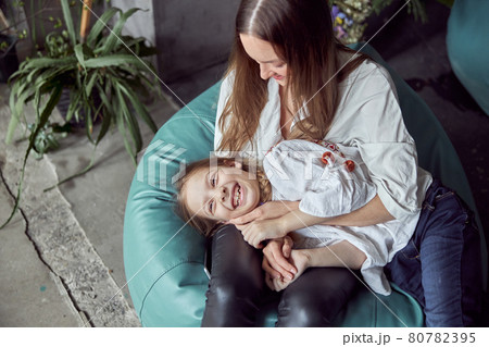 Happy caucasian mother with young beautiful cheerful daughter are having time together 80782395