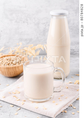 Vegan non dairy alternative milk. Oat milk on grey stone table 80784828