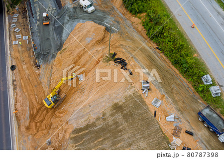 Aerial view workers heavy machinery joining the reconstruction of highway in USA Aerial view workers heavy machinery joining the reconstruction of highway in USA 80787398