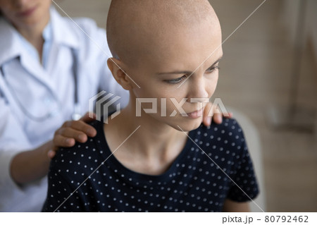 Depressed young female bald patient taking psychological support from doctor. 80792462