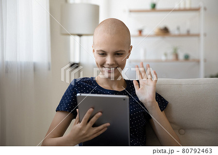 Happy young hairless woman holding video call meeting. 80792463