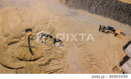 Top view of excavator working in construction site. Top view of excavator working in construction site. 80803099