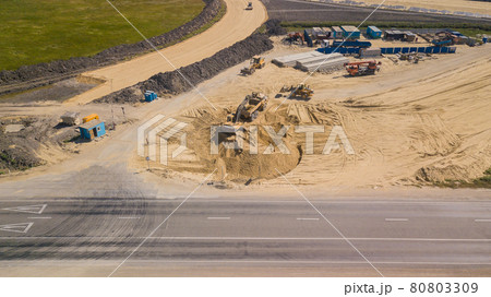 Excavator Is Loading Ground Into Truck On Construction Of Traffic Interchange Excavator Is Loading Ground Into Truck On Construction Of Traffic Interchange 80803309