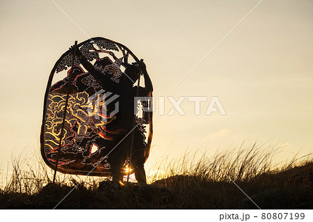 man hold Thai shadow angel puppet at sunset 80807199