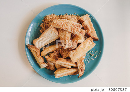 Toast sticks with barbecue flavor powder served on blue ceramic dish. Toast sticks with barbecue flavor powder served on blue ceramic dish. 80807387