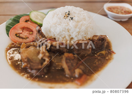 Thai stewed beef with rice served on white dish. Thai stewed beef with rice served on white dish. 80807396