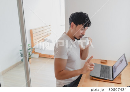 Man attend a meeting conference with his colleague while work from home. Man attend a meeting conference with his colleague while work from home. 80807424