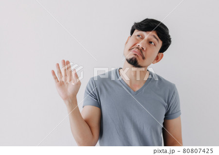Insolent denying face of man in blue t-shirt isolated on white background. Insolent denying face of man in blue t-shirt isolated on white background. 80807425