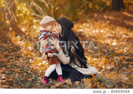 Cute and stylish family in a autumn park Cute and stylish family in a autumn park 80809088