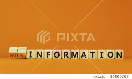 Information or misinformation symbol. Turned cubes and changed the word misinformation to information. Orange background, copy space. Business and information or misinformation concept. Information or misinformation symbol. Turned cubes and changed the word misinformation to information. Orange background, copy space. Business and information or misinformation concept. 80809207