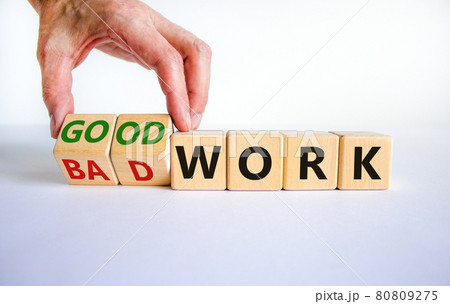 Good or bad work symbol. Businessman turns wooden cubes and changes words 'bad work' to 'good work'. Beautiful white background, copy space. Business and good or bad work concept. 80809275