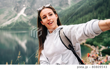 Blogger girl. Young female travel photographer with smartphone on summer mountain rock nature background. Freedom, summer travel, profession concept. Blogger girl. Young female travel photographer with smartphone on summer mountain rock nature background. Freedom, summer travel, profession concept. 80809543