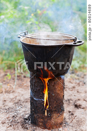 Cooking on Scandinavian log candle 80814689