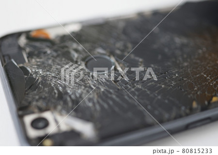 Badly broken black smartphone on white background Badly broken black smartphone on white background 80815233