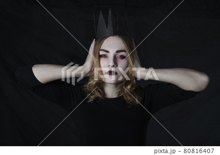 Women in halloween costume with crown in studio Women in halloween costume with crown in studio 80816407