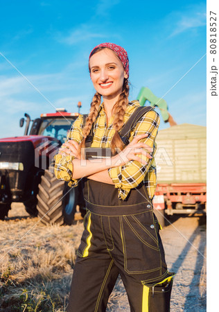 Proud famer standing in front of agricultural machinery Proud famer standing in front of agricultural machinery 80818527
