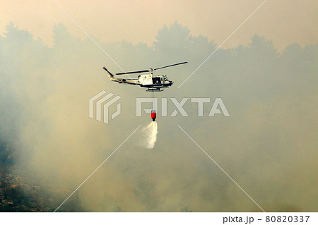 A helicopter extinguishes a fire in the mountains on the border between Israel and Lebanon 80820337