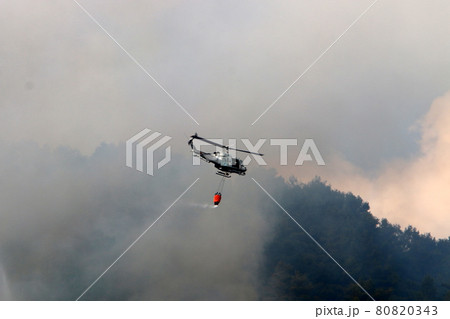 A helicopter extinguishes a fire in the mountains on the border between Israel and Lebanon 80820343